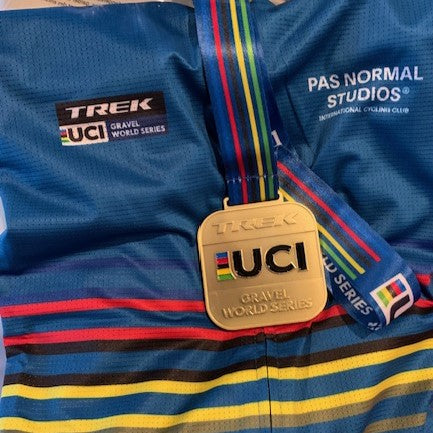 The UCI gravel World Series medal on a UCI cycling jersey.