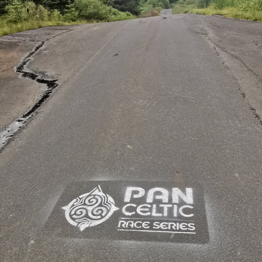 The Pan Celtic logo on a tarmac road.