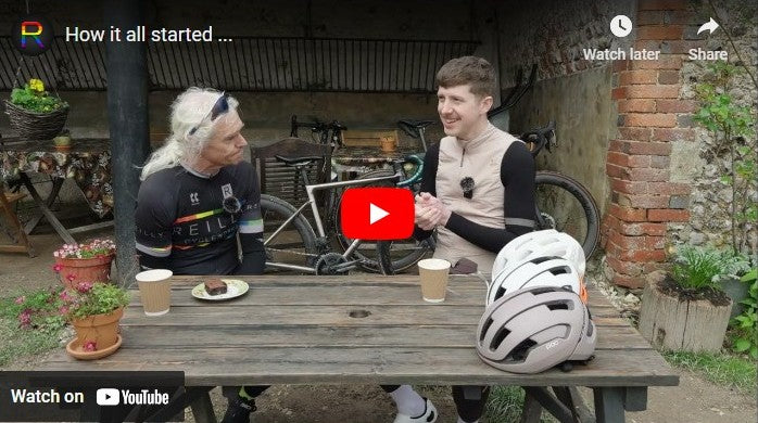 Load video: Grant talking to Reilly boss Neil, they both sit at a wooden table with bikes in the background. 